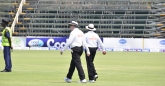 The two umpires Steve Davis  from Australia and Ranmore Martinesz from Sri Lanka walk out for a day in the sun.