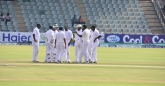 The team come together after the first wicket.