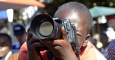 Young kid has a go at photographer, Nikon