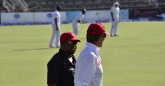 Coach Waller and his assistant Steve Mangongo have a chat as they walk around the field during play.