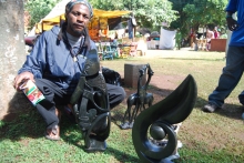 Sculptor with some of his work