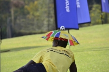 A fan with an umbrella hat.